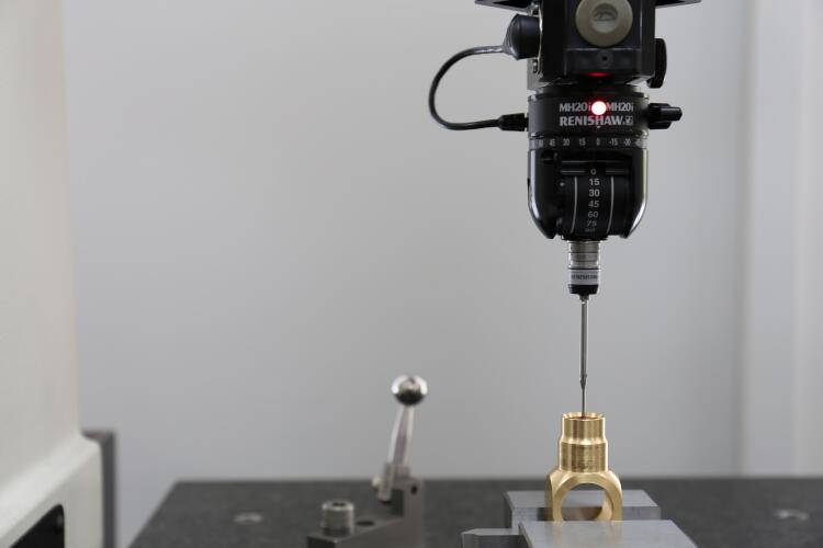 A close-up view of a probe performing a precision measurement on a brass fitting. This highlights the quality control process in Flowflex manufacturing to ensure accuracy and adherence to specifications.